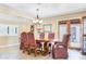 Dining room featuring a wood table with upholstered chairs and an exit to the backyard at 12212 N 66Th St, Scottsdale, AZ 85254