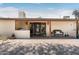 Charming covered patio with brick flooring, wooden posts, and decorative accents at the front entrance at 12212 N 66Th St, Scottsdale, AZ 85254