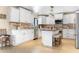 Bright kitchen featuring white cabinetry, stainless steel appliances, and a center island with seating at 12212 N 66Th St, Scottsdale, AZ 85254