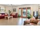 Inviting living room with tiled floors, comfortable seating, and large windows offering backyard views at 12212 N 66Th St, Scottsdale, AZ 85254