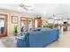 Inviting living room features a comfortable blue sofa and views of the outdoor pool area through glass doors at 12212 N 66Th St, Scottsdale, AZ 85254