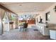Outdoor kitchen and dining area under a covered patio, featuring a built-in grill and ample counter space at 12212 N 66Th St, Scottsdale, AZ 85254