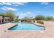 Refreshing backyard pool surrounded by a brick patio and desert landscaping, perfect for enjoying sunny days at 12212 N 66Th St, Scottsdale, AZ 85254