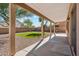 Covered back patio offering a serene view of the yard, complemented by stone and artificial grass at 1239 W Descanso Canyon Dr, Casa Grande, AZ 85122