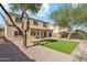 Large backyard featuring lush green lawn, desert landscaping, and covered patio at 1239 W Descanso Canyon Dr, Casa Grande, AZ 85122