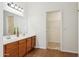 Bathroom featuring a double vanity, a large mirror, and wood cabinets at 1239 W Descanso Canyon Dr, Casa Grande, AZ 85122