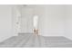 Bright, carpeted bedroom with neutral walls and a doorway leading to another room or closet at 1239 W Descanso Canyon Dr, Casa Grande, AZ 85122