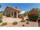 Beautiful backyard patio area with lush landscaping, seating, and a tiled roof overhead at 13041 S 45Th Pl, Phoenix, AZ 85044