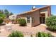 Charming backyard view showcasing a patio with seating, lovely foliage, and the home's architecture at 13041 S 45Th Pl, Phoenix, AZ 85044