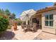 Inviting backyard with outdoor seating, a decorative umbrella, and well-manicured landscaping at 13041 S 45Th Pl, Phoenix, AZ 85044