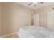 Neutral tone bedroom with ceiling fan and a nice view of the door at 13041 S 45Th Pl, Phoenix, AZ 85044