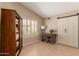 Neutral bedroom featuring shuttered windows, barn door closet, stylish furnishings, and tiled flooring at 13041 S 45Th Pl, Phoenix, AZ 85044