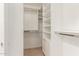 Walk in closet with lots of shelving, cabinets and clothing bars at 13041 S 45Th Pl, Phoenix, AZ 85044