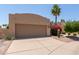 Charming single-story home with a two-car garage, desert landscaping, and flowering shrubs at 13041 S 45Th Pl, Phoenix, AZ 85044