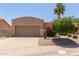 Charming single-story home with a two-car garage, desert landscaping, and a palm tree in the front yard at 13041 S 45Th Pl, Phoenix, AZ 85044
