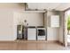 Garage featuring a water heater, water softener, and a washer and dryer set at 13041 S 45Th Pl, Phoenix, AZ 85044