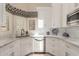Well-lit kitchen with stainless steel dishwasher and sink, complemented by white cabinets at 13041 S 45Th Pl, Phoenix, AZ 85044