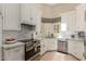 Updated kitchen featuring marble backsplash, white cabinets, and stainless steel appliances at 13041 S 45Th Pl, Phoenix, AZ 85044