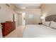 Spacious bedroom featuring neutral tones, with en suite bathroom, and a large wood dresser at 13041 S 45Th Pl, Phoenix, AZ 85044