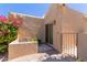 Charming courtyard patio with desert landscaping, privacy wall, seating, and gated access to the home at 13041 S 45Th Pl, Phoenix, AZ 85044