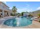 Sparkling pool offers a refreshing escape, complete with a small waterfall and ample space for relaxation at 13824 W Gelding Dr, Surprise, AZ 85379