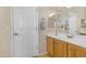 Bathroom with a bright vanity, a sink, and a white door at 13824 W Gelding Dr, Surprise, AZ 85379