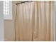 Shower in a bathroom featuring a white shower curtain at 13824 W Gelding Dr, Surprise, AZ 85379
