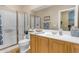 Bathroom featuring a shower, vanity with a sink, and tiled floors at 13824 W Gelding Dr, Surprise, AZ 85379