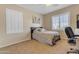Bedroom with neutral colored carpet, white plantation shutters, and a ceiling fan at 13824 W Gelding Dr, Surprise, AZ 85379