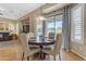 Bright breakfast nook featuring a round table, comfortable seating, and a view of the outdoors at 13824 W Gelding Dr, Surprise, AZ 85379