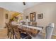 Formal dining area with stairway view featuring a wooden table and chairs, and decorative chandelier at 13824 W Gelding Dr, Surprise, AZ 85379