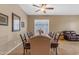 Cozy dining room with a full dining set, complemented by a window that brings in ample natural light at 13824 W Gelding Dr, Surprise, AZ 85379