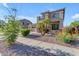 Two-story home showcasing lush landscaping with rocks, flowers, and plants that enhance the facade at 13824 W Gelding Dr, Surprise, AZ 85379