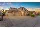 Charming two-story home with three-car garage, balcony, and manicured front yard at 13824 W Gelding Dr, Surprise, AZ 85379