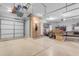Clean, organized garage space featuring ample lighting, storage and door to the exterior at 13824 W Gelding Dr, Surprise, AZ 85379