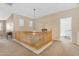 Upper hallway featuring carpeted floors, natural light, and a wooden banister at 13824 W Gelding Dr, Surprise, AZ 85379