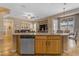 Spacious kitchen island with seating and stainless steel dishwasher, perfect for casual dining and entertaining at 13824 W Gelding Dr, Surprise, AZ 85379