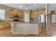 Well-lit kitchen with stainless steel appliances, granite countertops, and an island with a sink at 13824 W Gelding Dr, Surprise, AZ 85379