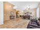 Open-concept living space boasting high ceilings, tile floors, and a staircase to the second level at 13824 W Gelding Dr, Surprise, AZ 85379