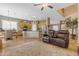 Bright living room with an open floor plan to the kitchen and stairs at 13824 W Gelding Dr, Surprise, AZ 85379
