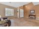 Light-filled living room showcases tile flooring, tall ceilings, and large windows at 13824 W Gelding Dr, Surprise, AZ 85379
