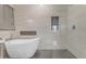 Luxurious bathroom featuring a soaking tub and spacious glass shower with gray hexagon tiles at 13824 W Gelding Dr, Surprise, AZ 85379
