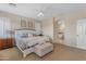 The main bedroom features neutral walls, carpet floors and a large entryway to the bathroom at 13824 W Gelding Dr, Surprise, AZ 85379