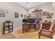 Office with tiled floors, a wooden desk, chair, and shelving at 13824 W Gelding Dr, Surprise, AZ 85379