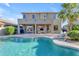 Inviting backyard featuring a pristine pool, covered patio with furniture, and a well-maintained lawn at 13824 W Gelding Dr, Surprise, AZ 85379