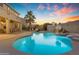 Inviting backyard featuring a pool, desert landscaping, shed, and a serene setting at 13824 W Gelding Dr, Surprise, AZ 85379