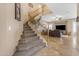 Carpeted staircase leads up to the second floor with wood banisters and natural light at 13824 W Gelding Dr, Surprise, AZ 85379