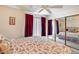 Comfortable bedroom featuring red floral patterned bedspread and mirrored closet doors at 14300 W Bell Rd # 312, Surprise, AZ 85374