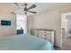 Bedroom featuring a dresser, cube shelving, and a glimpse into an adjacent bathroom at 14300 W Bell Rd # 312, Surprise, AZ 85374
