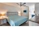 Bright bedroom featuring a modern ceiling fan and a serene blue comforter at 14300 W Bell Rd # 312, Surprise, AZ 85374